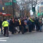 Protesters demonstrated in Central Square Tuesday to show support for increasing the minimum wage to $15 per hour.